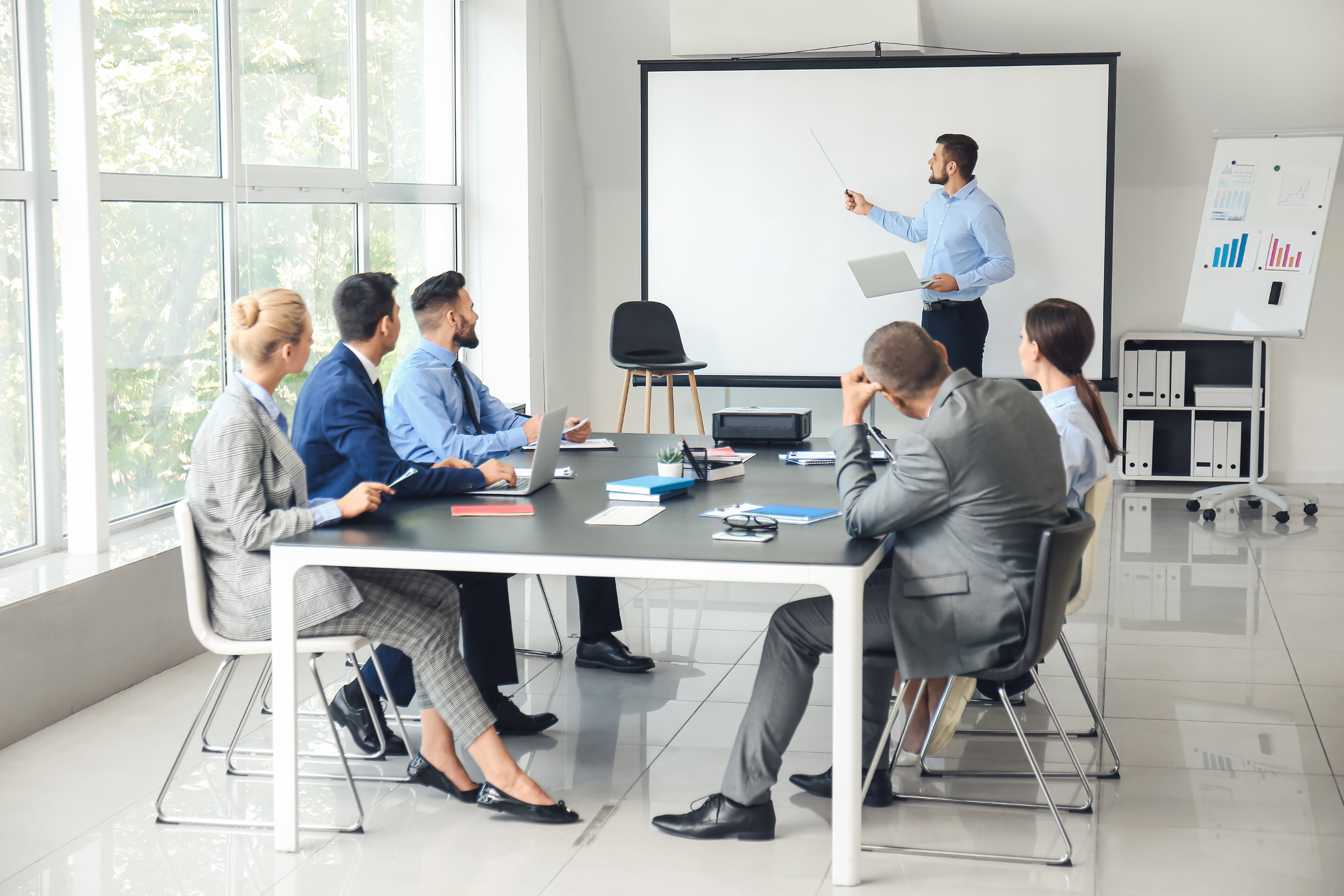 Tripod projector screen being used in a meeting room for a more engaging experience