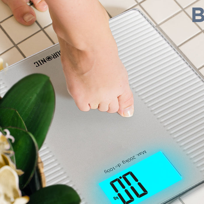 Zoomgoods BS204 digital bathroom scale calibrating weight on a tile floor
