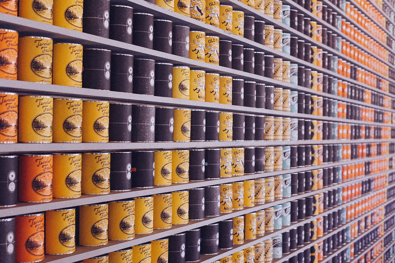 Canned food in tins on shelf to be opened using the Zoomgoods electric can opener