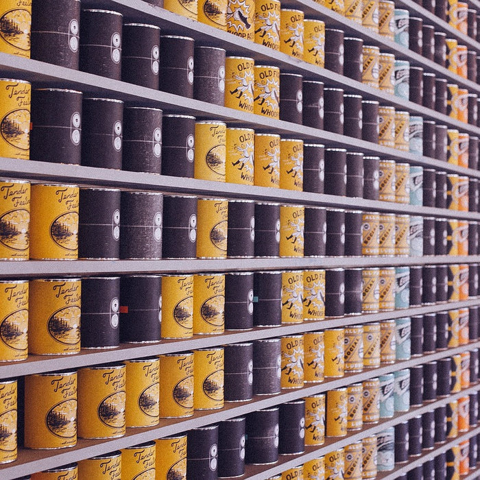 Canned food in tins on shelf to be opened using the Zoomgoods electric can opener
