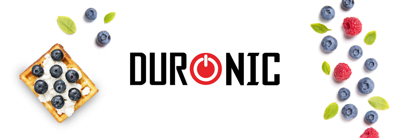 Blueberry waffles surrounded by blueberries and raspberries made using the Zoomgoods electric waffle maker