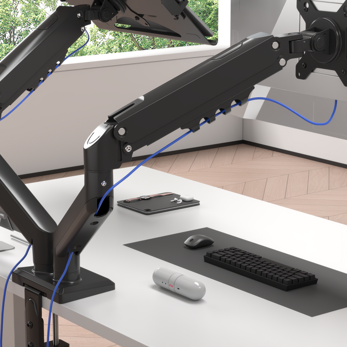 Zoomgoods Dual Monitor Stand Black dual monitor desk mount with cable management, securely clamped to a white desk