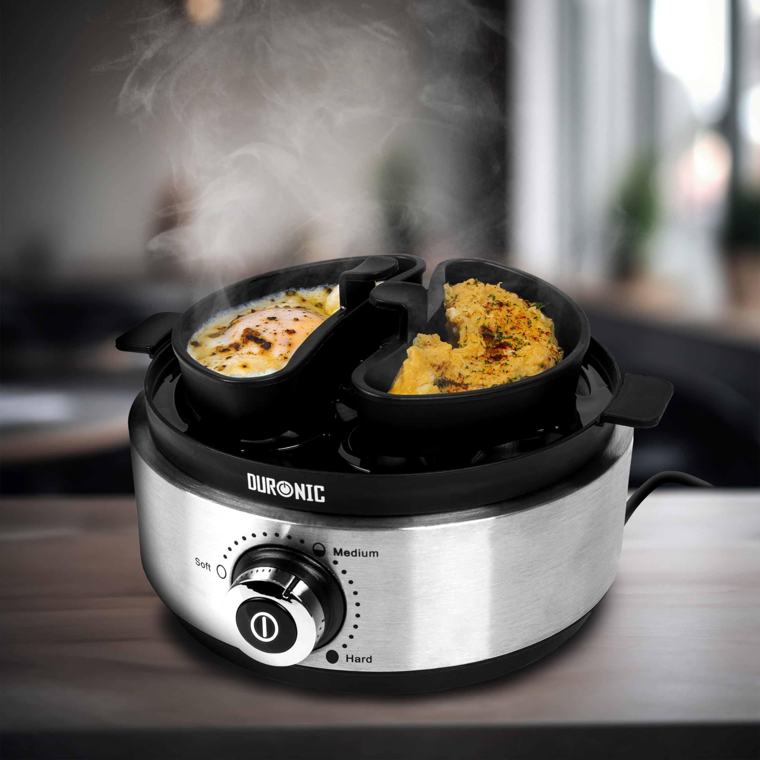 Zoomgoods EB40 BK electric egg boiler cooking eggs in the omelette trays provided, placed aesthetically on a table